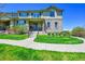 Charming two-story home boasts stone accents, a well-maintained lawn, and a welcoming front porch at 5906 S Youngfield Way, Littleton, CO 80127