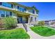 Inviting two-story home boasts stone accents, a well-maintained lawn, and a charming front porch at 5906 S Youngfield Way, Littleton, CO 80127