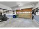 Spacious garage with work benches, storage racks, and an automatic door at 5906 S Youngfield Way, Littleton, CO 80127