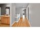 Neutral hallway with wood floors and a bathroom featuring a light wood vanity at 5906 S Youngfield Way, Littleton, CO 80127