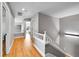 Bright hallway with modern floors and neutral color palette featuring a staircase at 5906 S Youngfield Way, Littleton, CO 80127