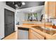 Kitchen features hardwood floors, natural wood cabinets, and a stainless steel dishwasher at 5906 S Youngfield Way, Littleton, CO 80127