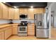 Kitchen features stainless steel appliances, plenty of cabinet space, and hardwood floors at 5906 S Youngfield Way, Littleton, CO 80127