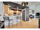 Open kitchen offers bar seating, stainless steel appliances, and hardwood floors at 5906 S Youngfield Way, Littleton, CO 80127