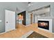 Open-concept living room showcasing a fireplace, hardwood floors, and seamless flow to the kitchen at 5906 S Youngfield Way, Littleton, CO 80127