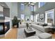 Bright living room features tall windows, a sleek fireplace, and modern decor at 5906 S Youngfield Way, Littleton, CO 80127