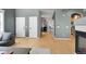 Spacious living area features hardwood floors and an open layout leading to kitchen and dining areas at 5906 S Youngfield Way, Littleton, CO 80127