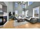 Bright living room with high ceilings, a fireplace, large sectional couch, and lots of natural light at 5906 S Youngfield Way, Littleton, CO 80127