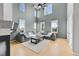 Bright living room with high ceilings, a fireplace, large sectional couch, and lots of natural light at 5906 S Youngfield Way, Littleton, CO 80127