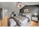 A primary bedroom features modern decor, a ceiling fan, and hardwood flooring at 5906 S Youngfield Way, Littleton, CO 80127
