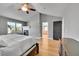 Inviting main bedroom with hardwood floors, vaulted ceiling, and fireplace with access to the ensuite bathroom at 5906 S Youngfield Way, Littleton, CO 80127