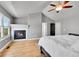 Serene main bedroom with fireplace, hardwood floors, and vaulted ceiling features cozy and inviting design at 5906 S Youngfield Way, Littleton, CO 80127