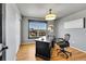 Bright office with hardwood flooring, a dark wood desk, and a window view at 5906 S Youngfield Way, Littleton, CO 80127