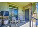 Outdoor porch has cozy seating, a sliding glass door, and decorative stone accents at 5906 S Youngfield Way, Littleton, CO 80127