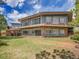 Two-story home featuring a stone facade, large windows, and a deck with metal railing, all set on a well-maintained lawn at 323 Paradise Rd, Golden, CO 80401