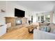 Bright living room with stone fireplace, wood floors, and comfortable seating arrangement at 323 Paradise Rd, Golden, CO 80401