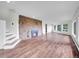 Spacious living room with a stone fireplace, hardwood floors, and large windows at 323 Paradise Rd, Golden, CO 80401