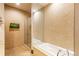 Bathroom with a soaking tub, walk-in shower, and stone tile at 975 N Lincoln St # 15A, Denver, CO 80203