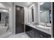 Elegant bathroom with double sinks, dark vanity, and large mirrors at 975 N Lincoln St # 15A, Denver, CO 80203