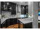 Modern kitchen with dark cabinetry, marble countertops and stainless steel appliances at 975 N Lincoln St # 15A, Denver, CO 80203