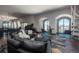 Open living room with city views, curved sectional sofa and grand piano at 975 N Lincoln St # 15A, Denver, CO 80203
