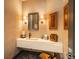 Stylish powder room with floating vanity and pebble floor at 975 N Lincoln St # 15A, Denver, CO 80203