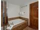 Relaxing bathroom featuring a soaking tub, tiled surround, and modern fixtures at 34 Highfield Trl # 311, Breckenridge, CO 80424