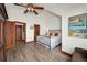 Spacious bedroom with a wrought iron bed, hardwood floors, and natural light at 34 Highfield Trl # 311, Breckenridge, CO 80424
