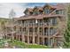 Multi-story condo building showcasing exterior balconies, stone accents, and well-maintained landscaping at 34 Highfield Trl # 311, Breckenridge, CO 80424