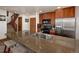Bright kitchen showcasing a large granite island with seating and stainless steel appliances at 34 Highfield Trl # 311, Breckenridge, CO 80424