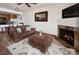 Inviting living room with a fireplace, comfortable seating, an ottoman, and a view to the dining area at 34 Highfield Trl # 311, Breckenridge, CO 80424