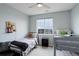 Cozy bedroom featuring a twin bed, bunk beds, and large windows for natural light at 12917 Fox St, Westminster, CO 80234