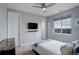 Bright bedroom with a ceiling fan, a large window, and a wall-mounted television at 12917 Fox St, Westminster, CO 80234