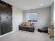 Versatile bonus room with a climbing wall, comfortable seating, and natural light at 12917 Fox St, Westminster, CO 80234
