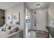 Inviting entryway with modern lighting, neutral tones, and an open view into the living area at 12917 Fox St, Westminster, CO 80234