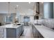 Spacious kitchen island offering bar seating, modern cabinetry, stainless steel appliances, and stylish pendant lighting at 12917 Fox St, Westminster, CO 80234