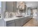 Elegant kitchen boasts gray cabinets, quartz countertops, a gas cooktop, and a stylish marble backsplash at 12917 Fox St, Westminster, CO 80234