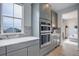 Well-equipped kitchen showcases gray cabinets, quartz countertops, stainless steel appliances, and built-in wine storage at 12917 Fox St, Westminster, CO 80234