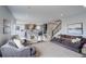 Expansive living area features a plush sofa, accent chairs, and a modern kitchen in an open layout at 12917 Fox St, Westminster, CO 80234