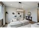 Serene living room with a comfortable sofa, modern lighting fixture, and chic decor for relaxation and style at 12917 Fox St, Westminster, CO 80234