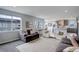 Open-concept living space boasts a comfy sofa, accent chairs, and a view of the kitchen with stylish decor at 12917 Fox St, Westminster, CO 80234