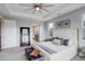 Spacious main bedroom featuring a tray ceiling, large mirror, and en-suite bathroom access at 12917 Fox St, Westminster, CO 80234