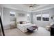 Airy main bedroom with large windows, neutral color palette, and cozy seating area at 12917 Fox St, Westminster, CO 80234