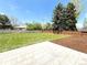 Large, well-maintained backyard with lush green grass, a stone patio, and fresh mulch; perfect for outdoor enjoyment at 375 Kendall St, Lakewood, CO 80226