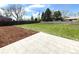 Expansive backyard featuring a lush lawn, stone patio, and mulch bed; creating an ideal outdoor living space at 375 Kendall St, Lakewood, CO 80226