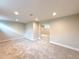 Bright finished basement with neutral paint and plush carpeting, creating a versatile and inviting living space at 375 Kendall St, Lakewood, CO 80226