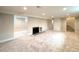 Spacious finished basement featuring plush carpeting, a modern fireplace, and neutral paint, ready for versatile use at 375 Kendall St, Lakewood, CO 80226