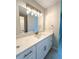 Bathroom featuring large vanity, modern lighting, and neutral paint at 375 Kendall St, Lakewood, CO 80226