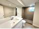 Modern bathroom featuring a sleek vanity, tiled shower with pebble floor, and contemporary fixtures at 375 Kendall St, Lakewood, CO 80226