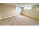 Bright carpeted bedroom with two windows, freshly painted, and ready for your personal touch at 375 Kendall St, Lakewood, CO 80226